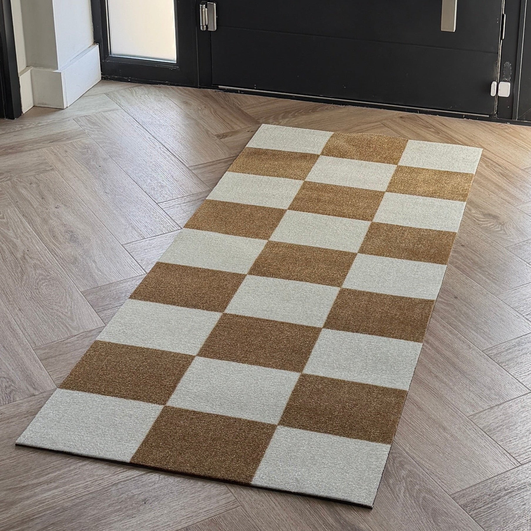 Checkered rug on a wooden floor in a modern interior setting